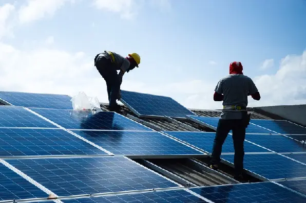Technicians installing solar panels